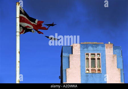 Torn union flag outside Charles Mannings amusement arcade, Felixstowe Suffolk, UK. Stock Photo