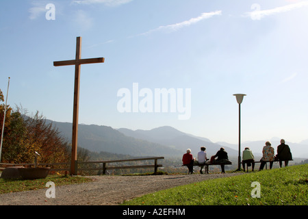 Visitors tourists and pilgrims enjoy the view from Calvary Hill towards the Alps Bad Toelz Bavaria Germany Stock Photo