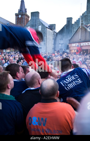 dh New Years day KIRKWALL ORKNEY Ba player launching himself onto the pack people mass scrum game scotland