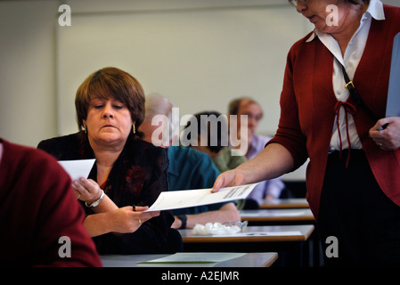 HELEN OUGHAM HANDS IN HER WINNING ENTRY AT THE TIMES NATIONAL CROSSWORD COMPETITION CUP FINAL DURING THE CHAMPIONSHIPS Stock Photo