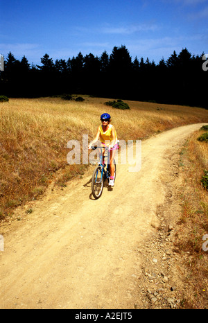 California Marin County Woman biking on Dipsea Trail in Muir Woods Stock Photo