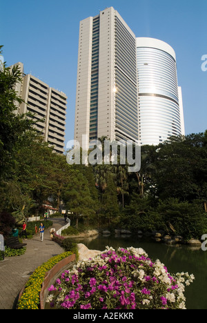 dh Hong Kong Park CENTRAL HONG KONG Path alongside Lotus pool blooming flowers Pacific Place buildings parks Stock Photo
