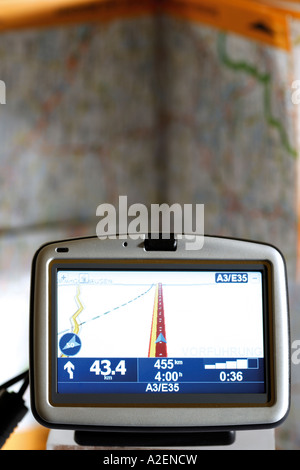 Navigation instrument in front of atlas Stock Photo