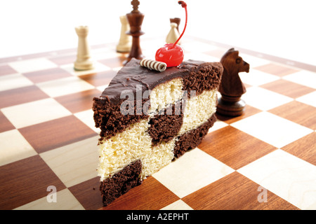 Piece of chess cake on chess board Stock Photo