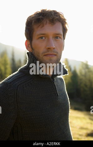 Germany, Bavaria, young man standing outdoors, portrait Stock Photo