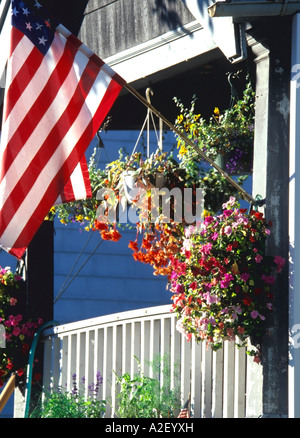 Flowers and American flag on front porch Milwaukee Wisconsin USA Stock Photo