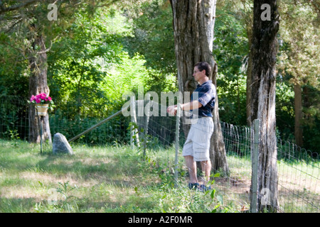 Thoughtful man at edge of cemetery. Blue River Wisconsin USA Stock Photo