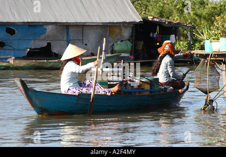 Women sailing their boat on the Tonle Sap river in the Cambodia capital Phnom Penh Stock Photo