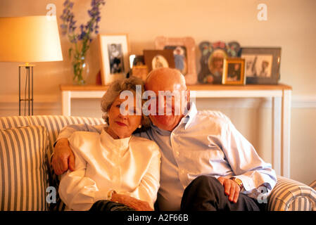 MATURE COUPLE SITTING ON SOFA Stock Photo