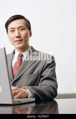 Portrait of a businessman using a laptop Stock Photo