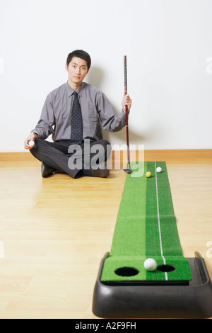 Portrait of a businessman sitting on the floor Stock Photo
