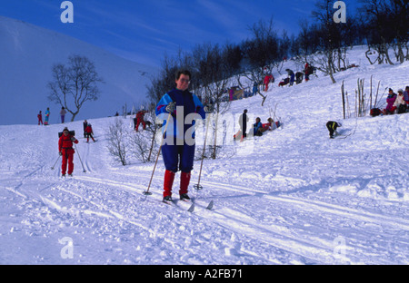 Skiers cross country skiing down a slope, Hinnøya, Troms, arctic Norway. Stock Photo