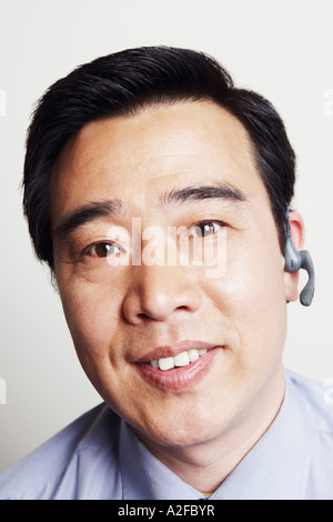 Portrait of a businessman wearing a hands free device smiling Stock Photo