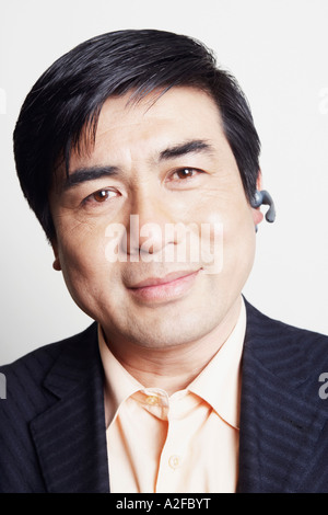 Portrait of a businessman wearing a hands free device smiling Stock Photo