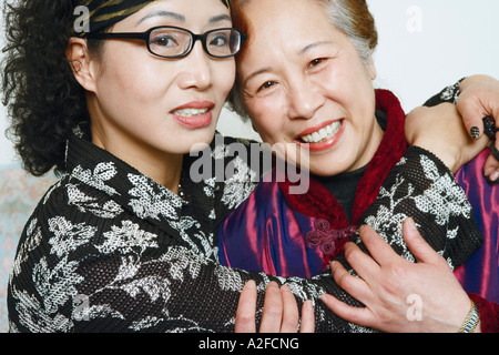 Portrait of a mature woman hugging her friend Stock Photo