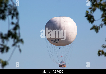 Hot air balloon drifting above Niagara Falls, Canada, during a scenic sunny day flight over the famous waterfall and gorge. Stock Photo