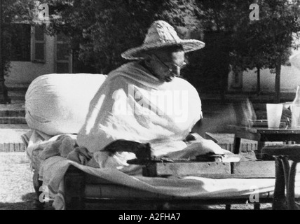 Mahatma Gandhi wearing a Noakhali hat whilst spinning at Birla House New Delhi India November 1947 Stock Photo