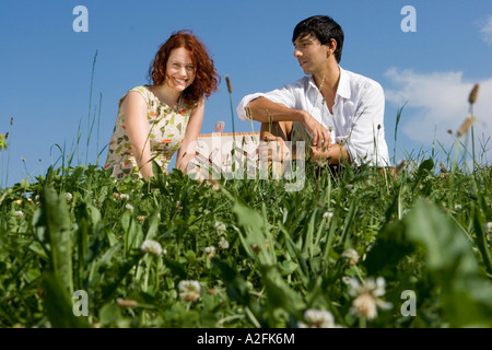 Young couple on picnic blanket Stock Photo