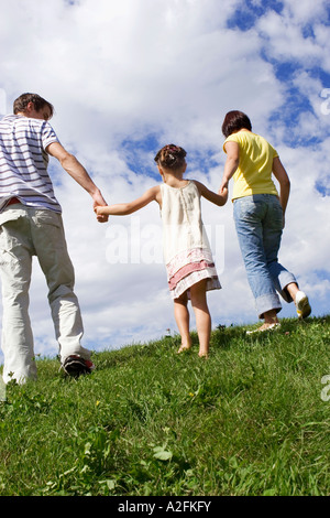 Rear view of kids and their parents walking in park Stock Photo - Alamy