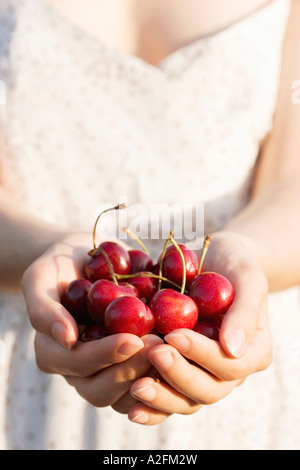 Woman holding cherries, close-up Stock Photo