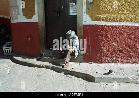 Old man in suit sitting on stairs in Guanajuato street,  Mexico Stock Photo