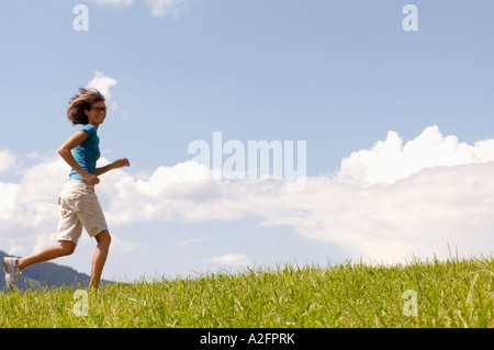 Young woman jogging, side view Stock Photo