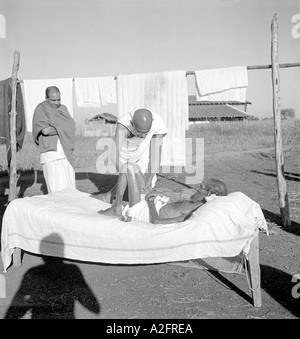 Mahatma Gandhi caring giving massage to a sick diseased leper patient at Sevagram Ashram Wardha Maharashtra India 1940 Stock Photo