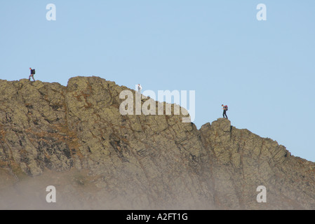 Walkers on the skyline walking along Sharp Edge on Blencathra in the English Lake District, Cumbria, United Kingdom. Stock Photo