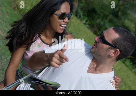 couple talking on motorcycle by rice field Stock Photo