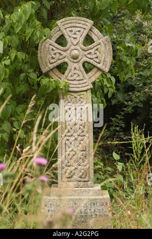A cross with celtic knotwork carvings in the graveyard at Lacock Wiltshire England