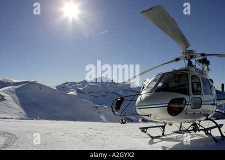 An alpine rescue helicopter lands on the Les Carroz Flaine Grand Massif in the Savoie region of the French Alps Stock Photo