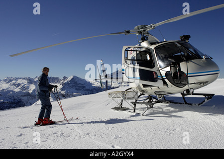 An alpine rescue helicopter lands on the Les Carroz Flaine Grand Massif in the Savoie region of the French Alps Stock Photo