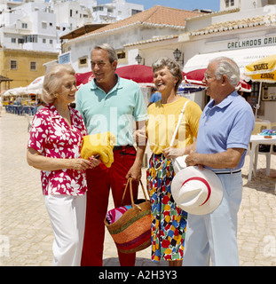 senior couples of retirement age chatting on holiday in street, Algarve, Portugal Stock Photo
