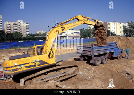 A JCB digger filling a dump truck in Poland. Stock Photo