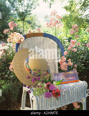Straw hat on garden chair Stock Photo - Alamy