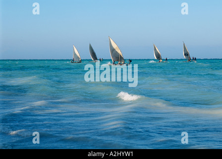 Small dhows race in Zanzibar's clear waters off Paje, on the island's east coast Stock Photo