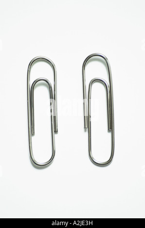 Two paperclips against white background close up Stock Photo