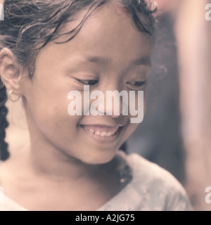 Young Nepalese girl smiling and looking away from camera. Stock Photo