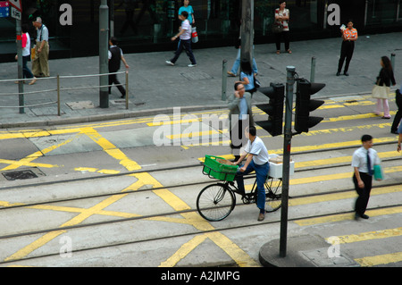 Hong Kong cyclist waiting at a stop light in Financial District. Stock Photo