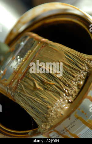Detail of paint brush resting on can. Stock Photo