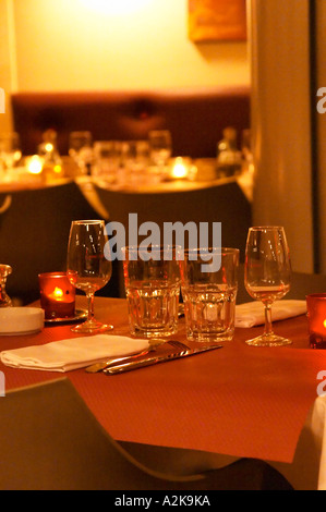 Interior of The restaurant Brunel at night. Tables with glasses, knives, forks, glasses. Candles.  Avignon, Vaucluse, Provence, Stock Photo
