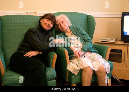 portrait woman/daughter/relative/care worker with old lady/mother in home Stock Photo
