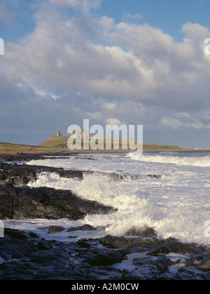 Dunstanburgh Castle ruins seen over a stormy sea, Castle Point, near Craster, Northumberland, England, UK. Stock Photo