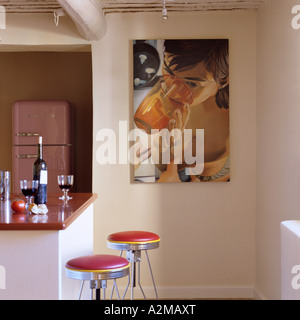 Artwork and barstools at breakfast bar Stock Photo