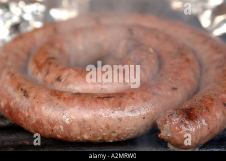 South African boerewors sausage cooking on a barbecue. Stock Photo