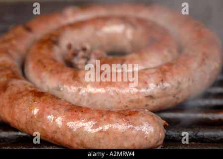 South African boerewors sausage cooking on a barbecue. Stock Photo
