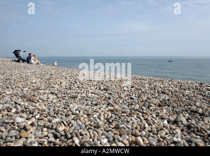 Couple and baby on the beach in the village of Beer Devon England Stock Photo