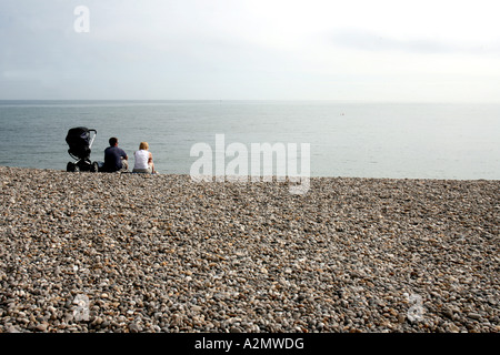 Couple and baby on the beach in the village of Beer Devon England Stock Photo