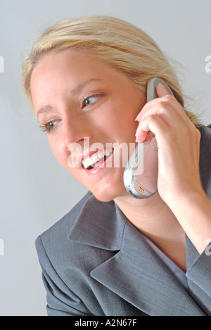 Woman in business suit talking on cell phone Stock Photo