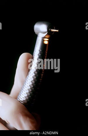 A dentist's hand holding a drill. Picture Jim Holden. Stock Photo
